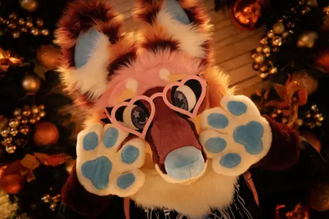 Heart-glasses headshot among holiday ornaments, photo by Beefshanks